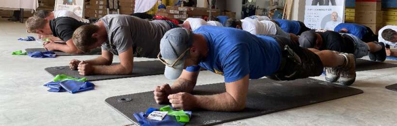 Handwerker machen Übungen am Arbeitsplatz, Projekt Fitness im Beruf von DAILY BREAD