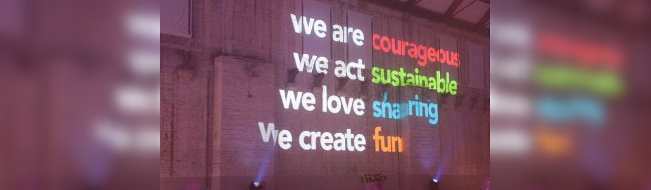Wall projection: we are courageous, we are sustainable, we love sharing