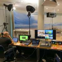 Controldesk with monitors, videomixer, livestream encoder, technician